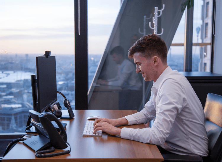 Client working in a fully equipped serviced office with a stunning view at the Leadenhall Building. 