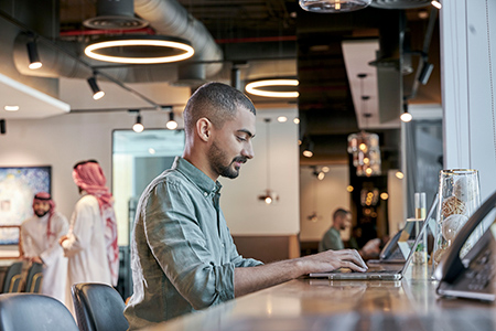 A professional focuses on work inside a modern Servcorp coworking space in Saudi Arabia, designed for productivity and flexibility.