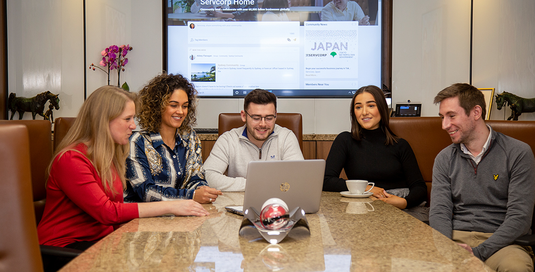 Clients meeting in a fully equipped boardroom with 5-star amenities and premium service.