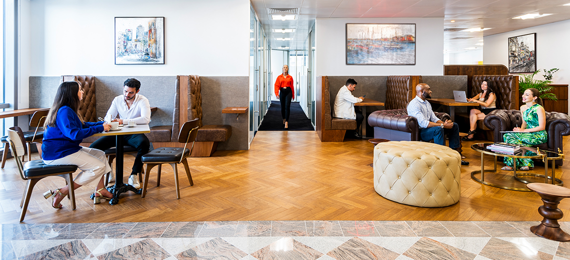 Clients working and brainstorming in a modern coworking space at Canary Wharf.