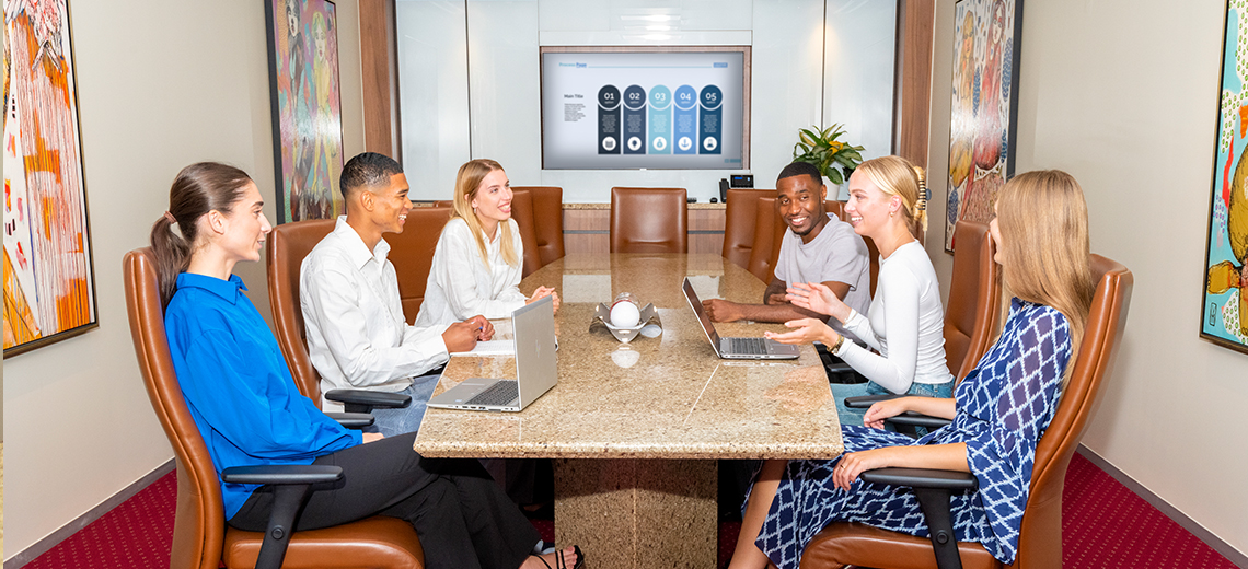 Clients meeting in a fully equipped boardroom with 5-star amenities and premium business support.