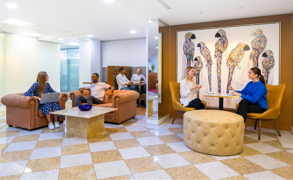 Clients working in 1 Mayfair Place coworking space featuring 5-star interiors, hot desks, and collaborative booths.