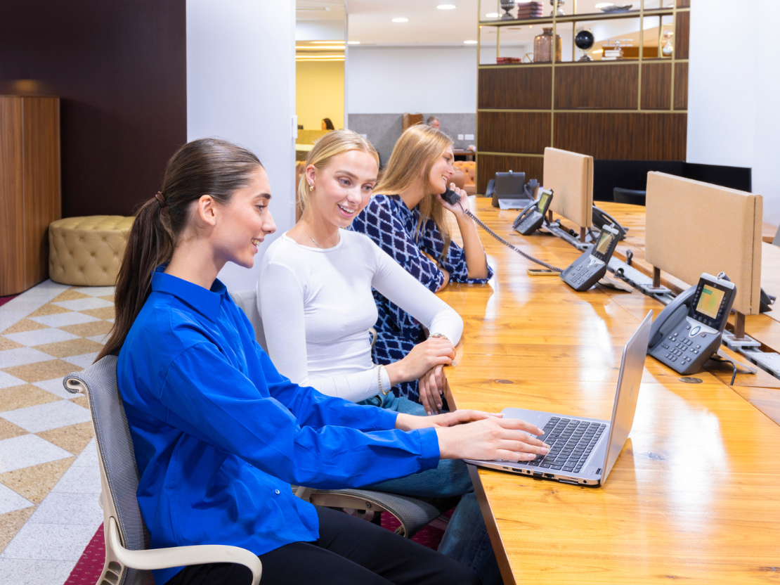 Clients working and networking at 1 Mayfair Place with 5-star interiors, a vibrant reception, and collaborative booths.