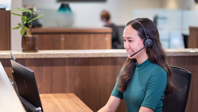 Servcorp receptionist answering and transferring calls to clients with professional service and efficiency.